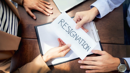 Man giving resignation letter to female boss