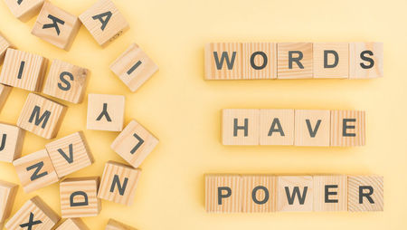 Wooden blocks spelling out the phrase 'words have power'