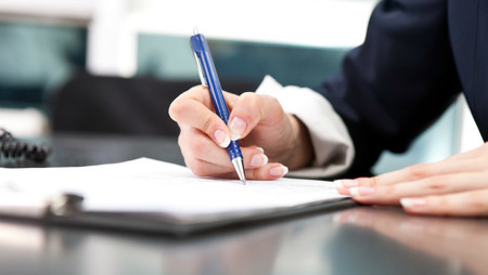 Close-up of a businesswoman signing a document
