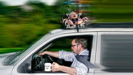 man with baby on car