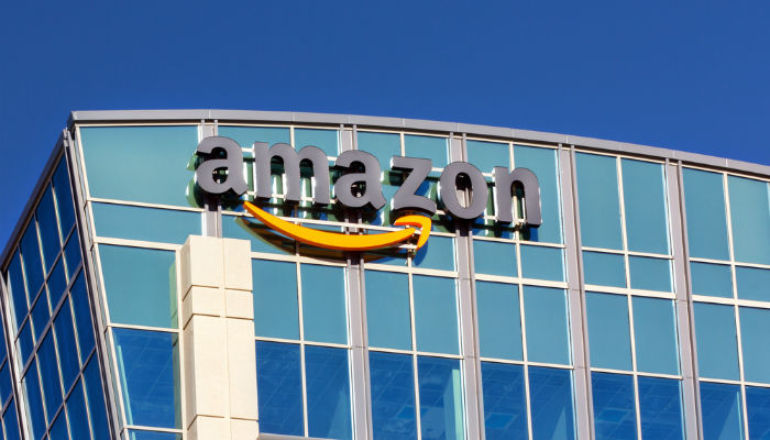 Close-up of Amazon brand sign atop a building