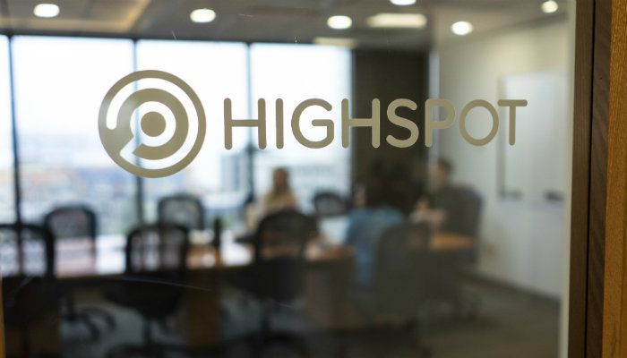 The Highspot logo on the window of a conference room