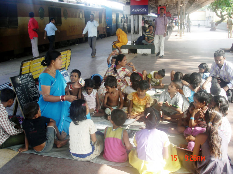 Train Platform School with group of children sitting in floor 