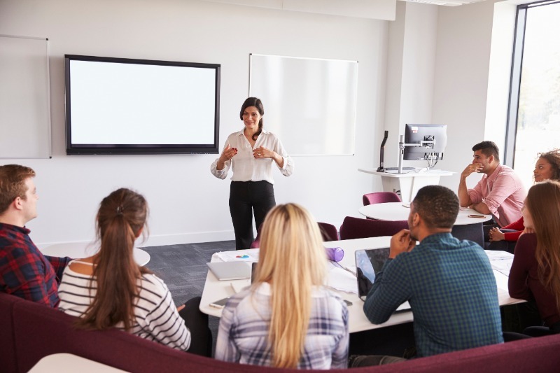 Art lecturer standing in front a group of students