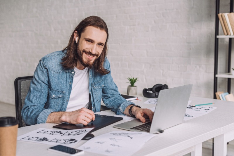 Animator sitting at a desk and working on a laptop