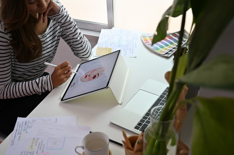 illustrator working on a design on a tablet