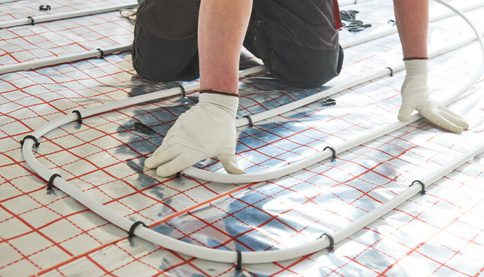 Tile fitter fitting underfloor heating