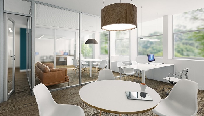 A minimalist office with white chairs and a wooden table in the foreground